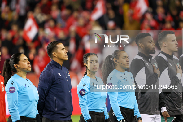 Katia Garcia and a match official stand during the national anthem at the CONCACAF Nations League Quarter Final Match between Team Canada an...