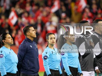 Katia Garcia and a match official stand during the national anthem at the CONCACAF Nations League Quarter Final Match between Team Canada an...