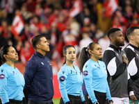 Katia Garcia and a match official stand during the national anthem at the CONCACAF Nations League Quarter Final Match between Team Canada an...