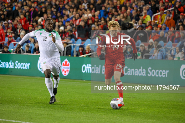 J. Shaffelburg #14 carries the ball while Myenty Abena #12 chases him at the CONCACAF Nations League Quarter Final Match between Team Canada...