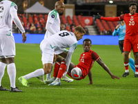 In Toronto, Ontario, Canada, on November 19, 2024, Richie Laryea battles with Justin Lonwijk #8 and other Suriname players during the CONCAC...