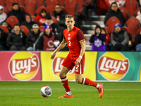 Alistair Johnston #2 is in action during the CONCACAF Nations League Quarter Final match between Team Canada and Suriname at BMO Field in To...