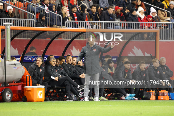 In Toronto, Ontario, Canada, on November 19, 2024, Team Canada's Head Coach Jesse Marsch gives instruction in front of the team bench at the...