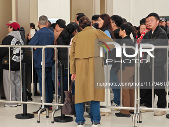 Customers who order Mate X6 foldable screen phones line up in batches at Huawei's global flagship store in Shanghai, China, on November 20,...