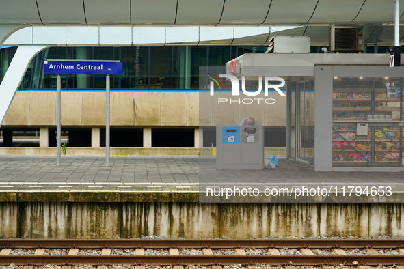 In Arnhem, Netherlands, on July 27, 2023, Arnhem Central Station captures the activity on one of the platforms. A man sorts through a recycl...