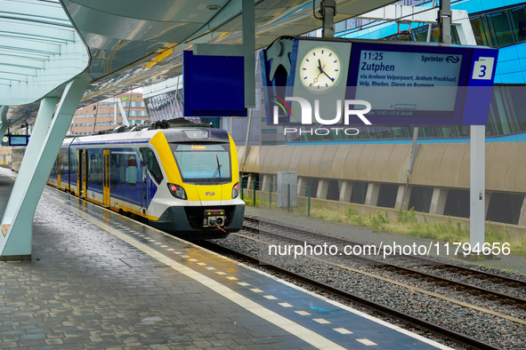 At Arnhem Centraal station in Arnhem, Netherlands, on July 27, 2023, a bright yellow-blue Sprinter train prepares to depart for Zutphen. The...