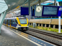 At Arnhem Centraal station in Arnhem, Netherlands, on July 27, 2023, a bright yellow-blue Sprinter train prepares to depart for Zutphen. The...