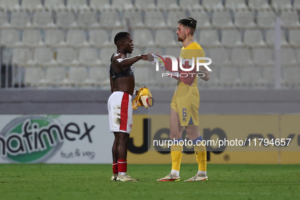 In Ta' Qali, Malta, on November 19, 2024, Basil Tuma of Malta and Christian Garcia of Andorra shake hands after the UEFA Nations League, Lea...