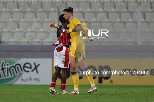 In Ta' Qali, Malta, on November 19, 2024, Basil Tuma of Malta and Christian Garcia of Andorra embrace each other after the UEFA Nations Leag...