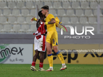 In Ta' Qali, Malta, on November 19, 2024, Basil Tuma of Malta and Christian Garcia of Andorra embrace each other after the UEFA Nations Leag...