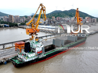 Vehicles shuttle back and forth, and cargo loading and unloading are orderly at Xinhai Wharf in Fuzhou, Fujian province, China, on November...