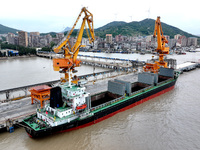 Vehicles shuttle back and forth, and cargo loading and unloading are orderly at Xinhai Wharf in Fuzhou, Fujian province, China, on November...