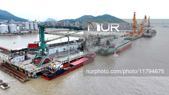 Vehicles shuttle back and forth, and cargo loading and unloading are orderly at Xinhai Wharf in Fuzhou, Fujian province, China, on November...