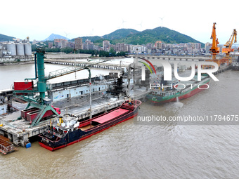 Vehicles shuttle back and forth, and cargo loading and unloading are orderly at Xinhai Wharf in Fuzhou, Fujian province, China, on November...