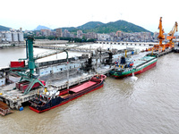 Vehicles shuttle back and forth, and cargo loading and unloading are orderly at Xinhai Wharf in Fuzhou, Fujian province, China, on November...