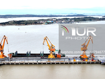 Vehicles shuttle back and forth, and cargo loading and unloading are orderly at Xinhai Wharf in Fuzhou, Fujian province, China, on November...