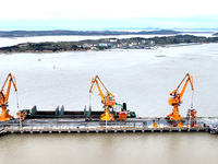 Vehicles shuttle back and forth, and cargo loading and unloading are orderly at Xinhai Wharf in Fuzhou, Fujian province, China, on November...