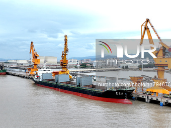 Vehicles shuttle back and forth, and cargo loading and unloading are orderly at Xinhai Wharf in Fuzhou, Fujian province, China, on November...