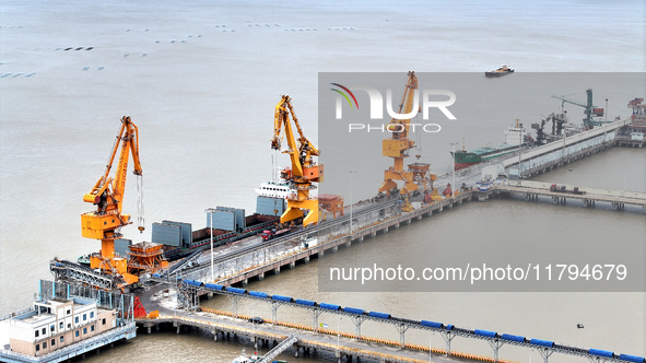 Vehicles shuttle back and forth, and cargo loading and unloading are orderly at Xinhai Wharf in Fuzhou, Fujian province, China, on November...