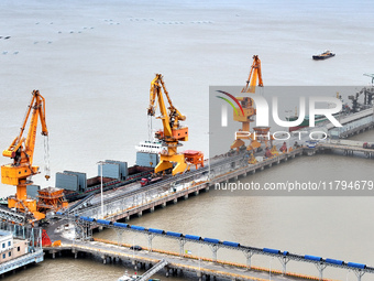 Vehicles shuttle back and forth, and cargo loading and unloading are orderly at Xinhai Wharf in Fuzhou, Fujian province, China, on November...