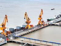 Vehicles shuttle back and forth, and cargo loading and unloading are orderly at Xinhai Wharf in Fuzhou, Fujian province, China, on November...