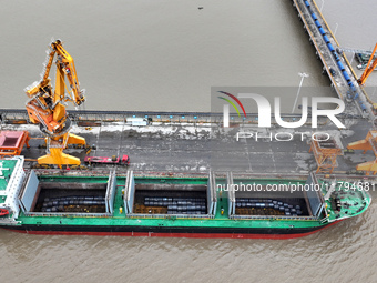 Vehicles shuttle back and forth, and cargo loading and unloading are orderly at Xinhai Wharf in Fuzhou, Fujian province, China, on November...