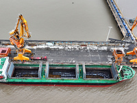 Vehicles shuttle back and forth, and cargo loading and unloading are orderly at Xinhai Wharf in Fuzhou, Fujian province, China, on November...