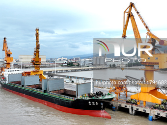 Vehicles shuttle back and forth, and cargo loading and unloading are orderly at Xinhai Wharf in Fuzhou, Fujian province, China, on November...