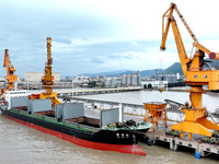 Vehicles shuttle back and forth, and cargo loading and unloading are orderly at Xinhai Wharf in Fuzhou, Fujian province, China, on November...