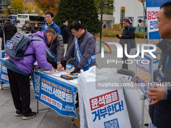 Democratic Party officials hold a 10 million signature campaign at Gwanghwamun Square in Seoul, South Korea, on November 20, condemning alle...