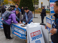 Democratic Party officials hold a 10 million signature campaign at Gwanghwamun Square in Seoul, South Korea, on November 20, condemning alle...