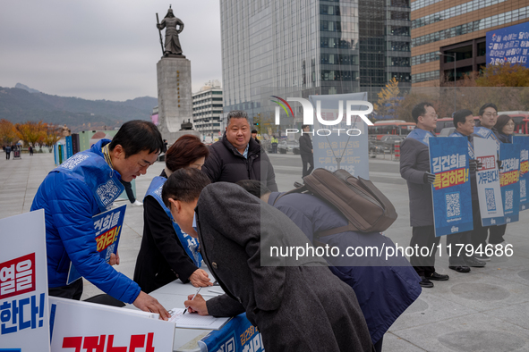 Democratic Party officials hold a 10 million signature campaign at Gwanghwamun Square in Seoul, South Korea, on November 20, condemning alle...