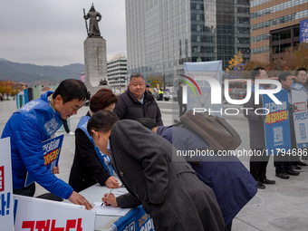 Democratic Party officials hold a 10 million signature campaign at Gwanghwamun Square in Seoul, South Korea, on November 20, condemning alle...