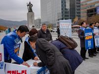 Democratic Party officials hold a 10 million signature campaign at Gwanghwamun Square in Seoul, South Korea, on November 20, condemning alle...