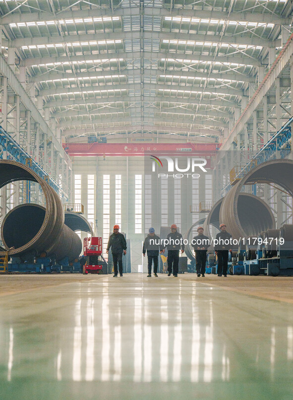 Police inspect an offshore wind power tower barrel manufacturing enterprise in Dongying City, East China, on November 20, 2024. 