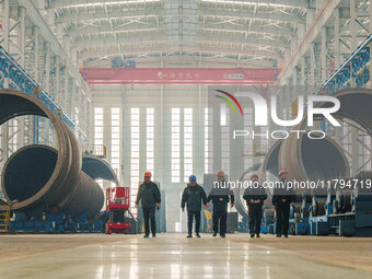 Police inspect an offshore wind power tower barrel manufacturing enterprise in Dongying City, East China, on November 20, 2024. (