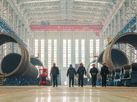 Police inspect an offshore wind power tower barrel manufacturing enterprise in Dongying City, East China, on November 20, 2024. (