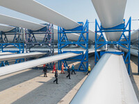 Police check the blades of offshore wind turbines stored at a port in Dongying City, East China, on November 20, 2024. (