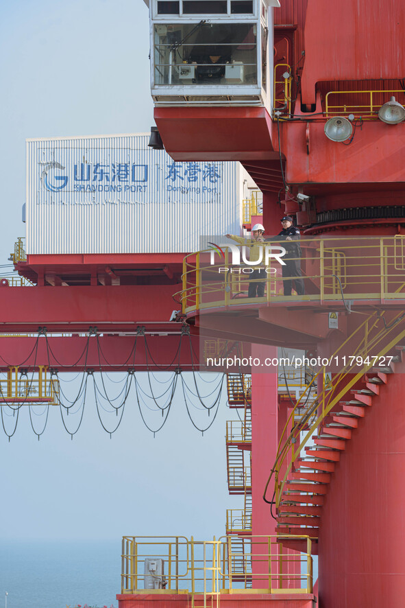 A policeman overlooks the port area in Dongying, China, on November 20, 2024. 