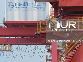 A policeman overlooks the port area in Dongying, China, on November 20, 2024. (