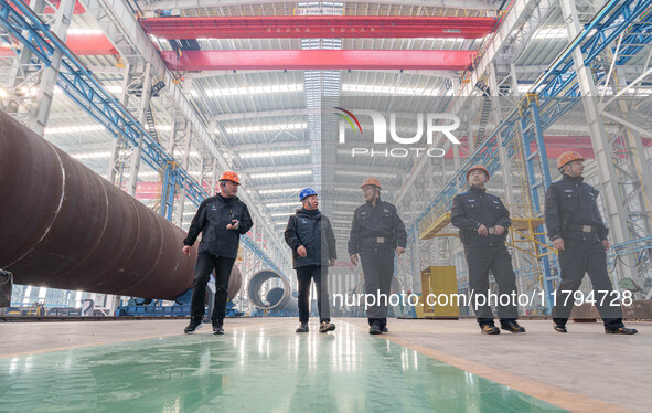 Police inspect an offshore wind power tower barrel manufacturing enterprise in Dongying City, East China, on November 20, 2024. 