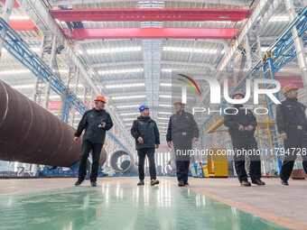 Police inspect an offshore wind power tower barrel manufacturing enterprise in Dongying City, East China, on November 20, 2024. (