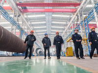 Police inspect an offshore wind power tower barrel manufacturing enterprise in Dongying City, East China, on November 20, 2024. (