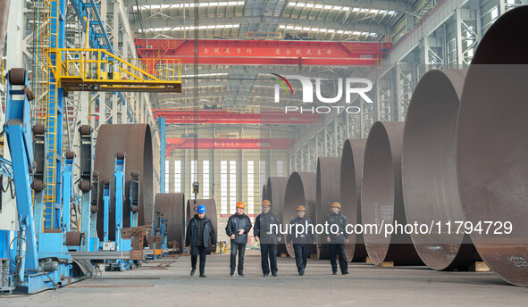 Police inspect an offshore wind power tower barrel manufacturing enterprise in Dongying City, East China, on November 20, 2024. 