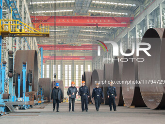 Police inspect an offshore wind power tower barrel manufacturing enterprise in Dongying City, East China, on November 20, 2024. (