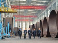 Police inspect an offshore wind power tower barrel manufacturing enterprise in Dongying City, East China, on November 20, 2024. (