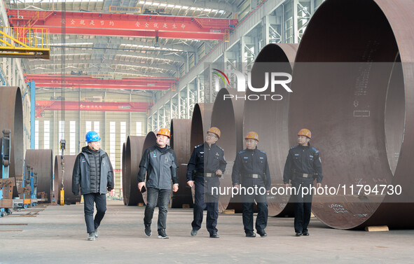 Police inspect an offshore wind power tower barrel manufacturing enterprise in Dongying City, East China, on November 20, 2024. 