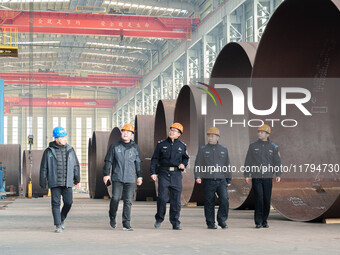 Police inspect an offshore wind power tower barrel manufacturing enterprise in Dongying City, East China, on November 20, 2024. (