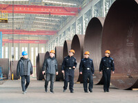 Police inspect an offshore wind power tower barrel manufacturing enterprise in Dongying City, East China, on November 20, 2024. (