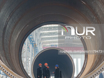 Police inspect an offshore wind power tower barrel manufacturing enterprise in Dongying City, East China, on November 20, 2024. (